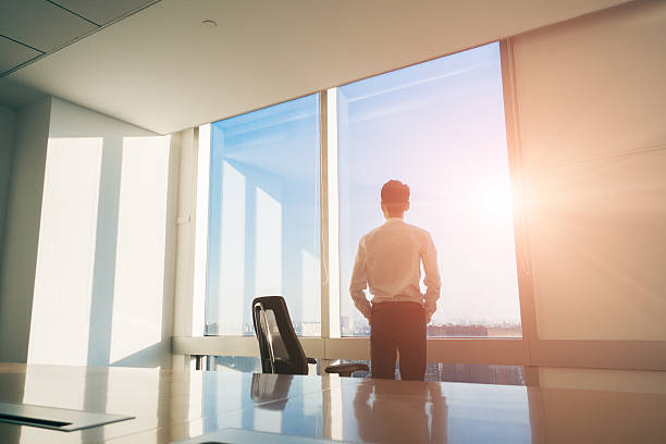 istock Businessman standing looking out of the window 495077424
