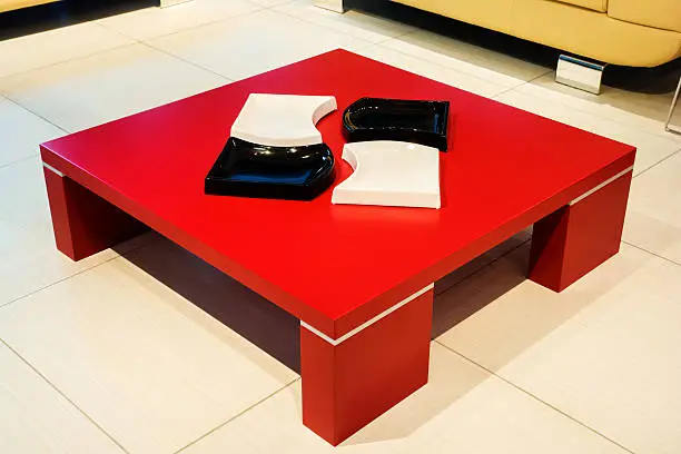 Red square coffee-table on the floor, modern interior detail