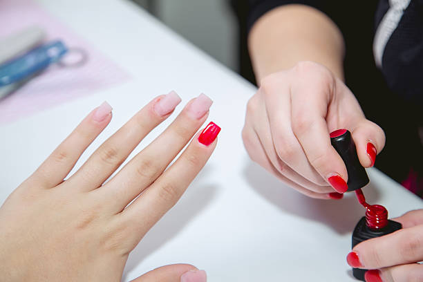 istock Paint lacquer red nails in beauty salon 495077906