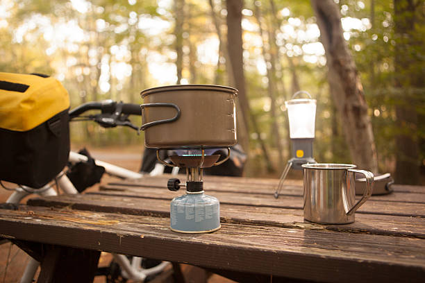 Heating up water at the campsite during a bikepacking trip stock photo