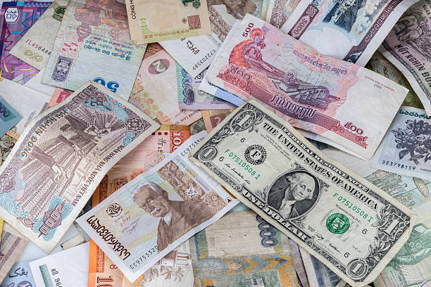 istock Many banknotes of different countries scattered on the table 495080568