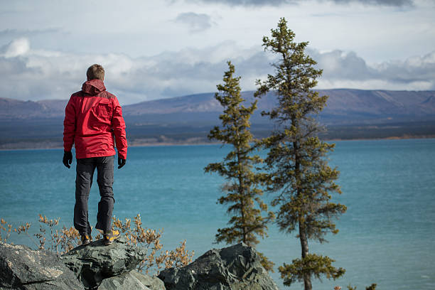 istock Hiker standing on cliff enjoying landscape 495080630