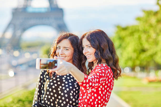 istock Beautiful twin sisters taking selfie in front of Eiffel Tower 495083968