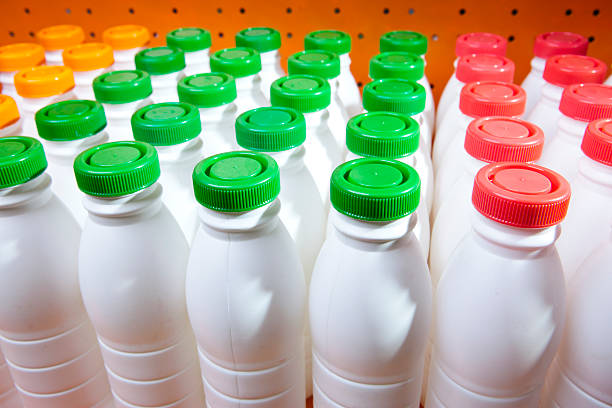 istock dairy products bottles stand in rows, bright covers 495084058