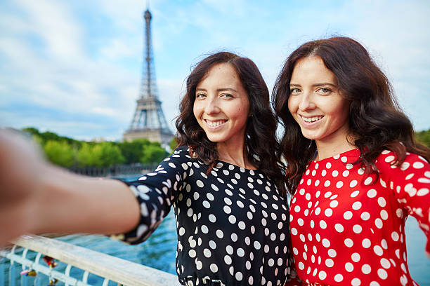 istock Beautiful twin sisters taking selfie 495084180