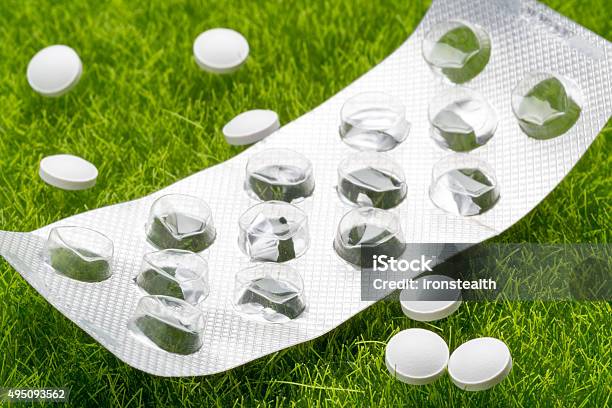 White Pills And Empty Pill Blister Pack Scattered On The Stock Photo - Download Image Now