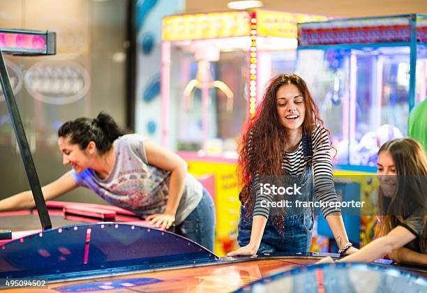 Friends Have Fun On The Game Room Stock Photo - Download Image Now - Amusement Arcade, Teenager, Adolescence