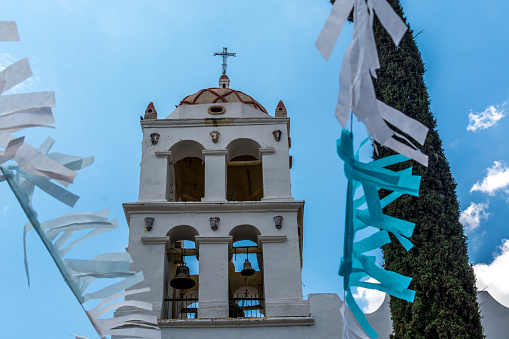 Mexican church with blue sky and streamers.  