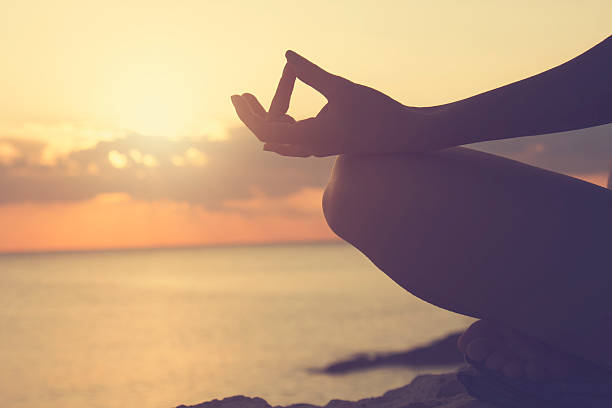 istock Young woman practicing yoga on the beach. 495096802