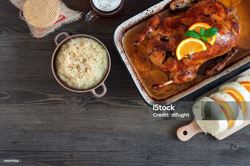 Delicious roasted duck with oranges in a pan, rustic style Delicious roasted duck with oranges and beer in a pan, rustic style Duck Meat Stock Photo