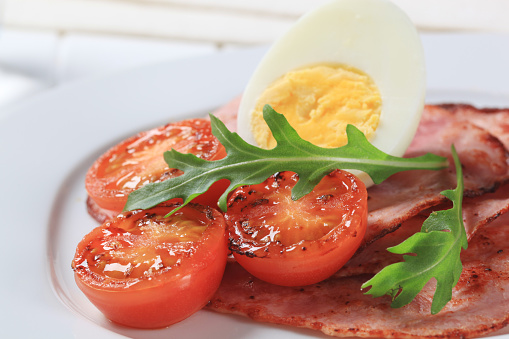 Hard boiled egg with ham and tomato