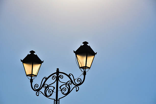 istock Street antique double lamp post and blue sky 495109902