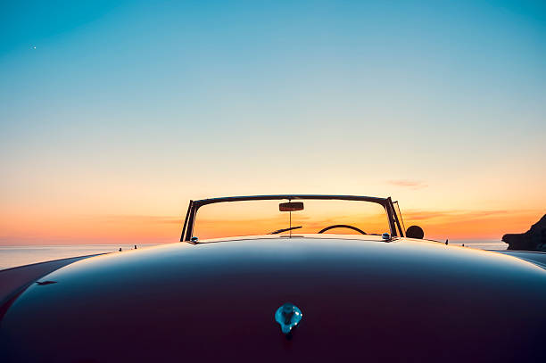 istock Convertible at the beach at sunset or sunrise. 495110962