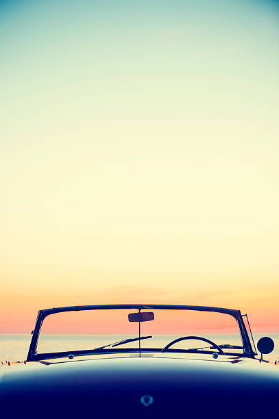 Convertible at the beach at sunset or sunrise
