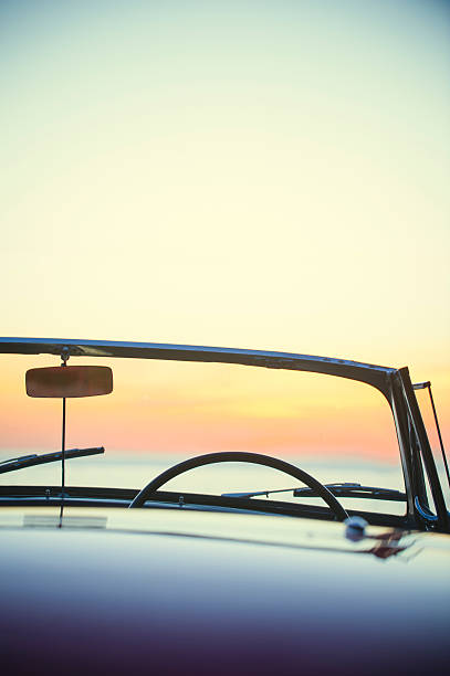 istock Convertible at the beach at sunset or sunrise 495111096