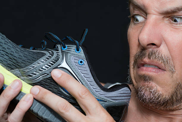 istock Man Disgusted By Shoes Smell 495114050