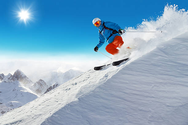 Man skier running downhill Man skier running downhill on sunny Alps slope skiing stock pictures, royalty-free photos & images