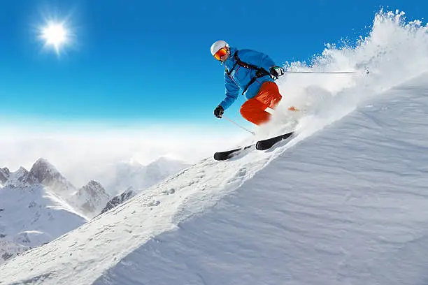 Photo of Man skier running downhill