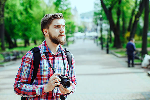 istock man holding old film camera 495115212