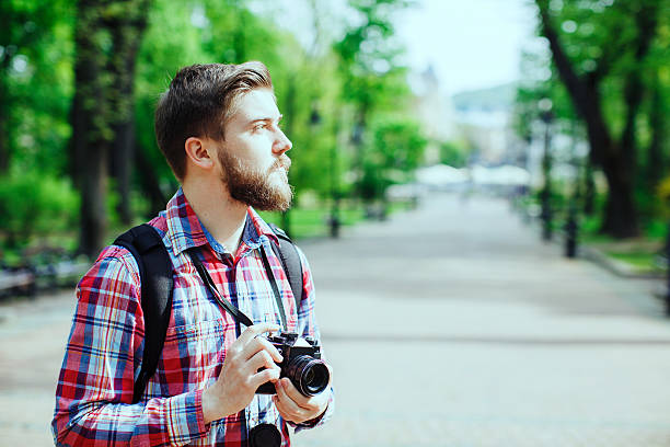 istock man holding old film camera 495115356