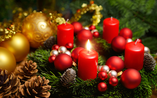 Studio shot of a nice advent wreath with baubles and one burning red candle