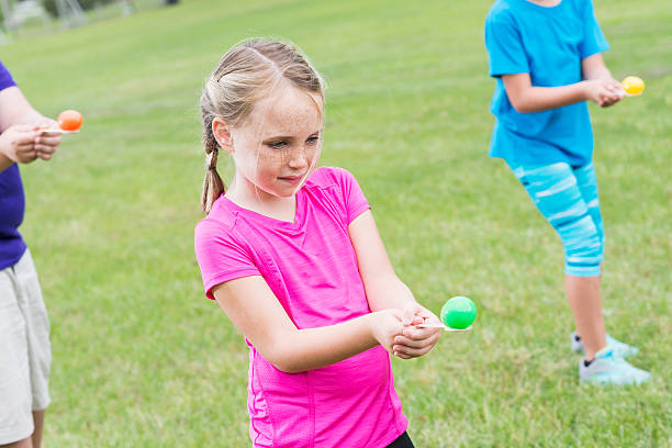 istock Young girl competing in an egg spoon race 495117510