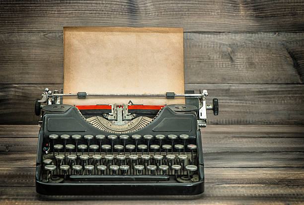 istock Antique typewriter with grungy worn paper page on wooden table 495117828