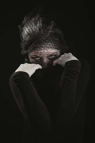 istock Woman in black peeking mysteriously 495118788