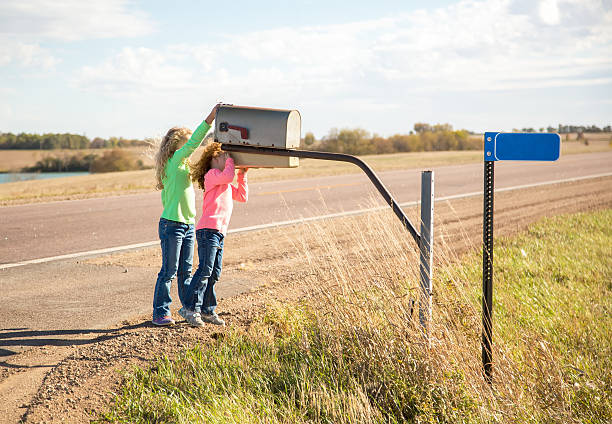 istock Two Girls Checking Rural Mailbox for Mail 495118896