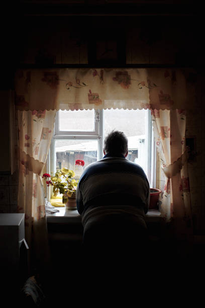 Grandfather looks out window