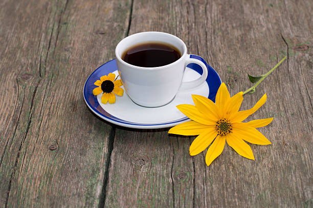 istock coffee on a wooden table decorated with two yellow  flowers 495119720
