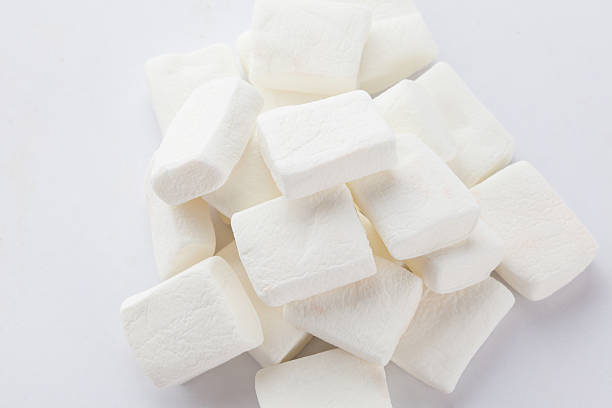 istock Pile of original white marshmallows in red pastel background. 495142338