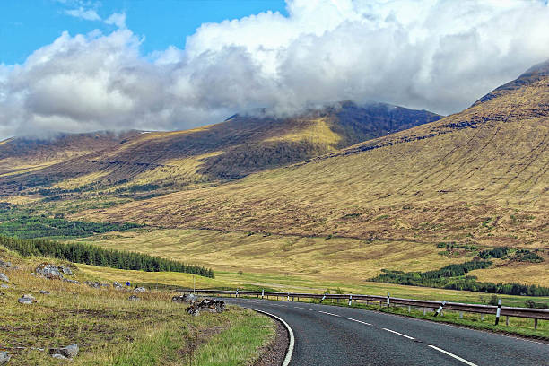 istock Long road between mountains in Scotland 495144162