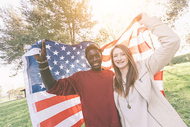 istock Multiracial Couple Holding American Flag 495144287