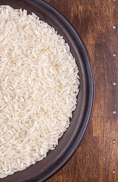 istock Plate of Rice on Dark Wood Background 495145537