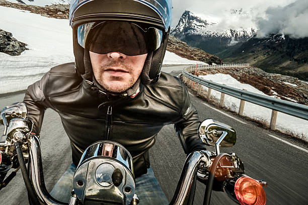 istock Biker in helmet and leather jacket racing on mountain serpentine 495146030