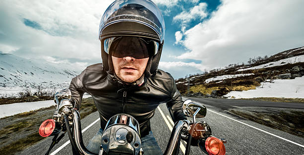 istock Biker in helmet and leather jacket racing on mountain serpentine 495146054