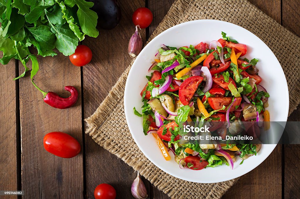 Salad baked eggplant and fresh tomatoes Salad baked eggplant and fresh tomatoes. Top view Salad Stock Photo