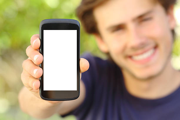 istock Happy man showing a blank mobile phone screen outdoor 495148191