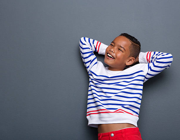 istock Young boy smiling with arms behind head 495149999