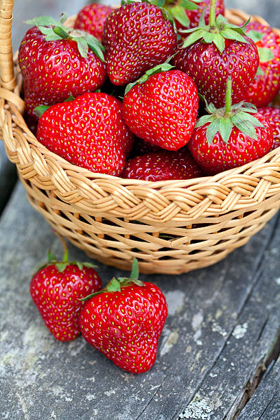 istock basket with strawberries on wooden surface 495150539
