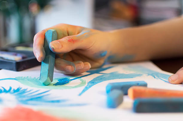 istock young women hand draw with colored chalk 495151351