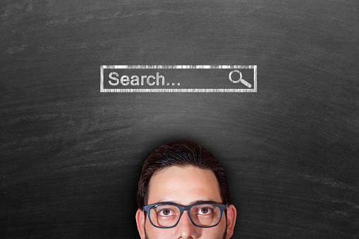 Search analysis, look for, search for and seek concept. Cropped face of a man looking up search bar drawn over his head