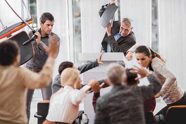 Large group of business people having a fight on seminar. Business people started a fight during an educational event at convention center. chaos stock pictures, royalty-free photos & images