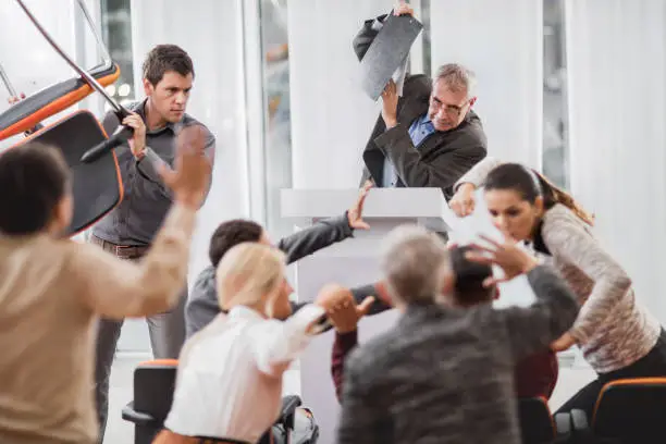 Photo of Large group of business people having a fight on seminar.