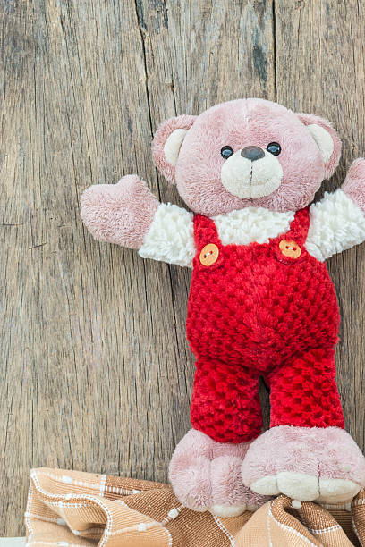 istock Cute teddy bear with old wood background 495174896