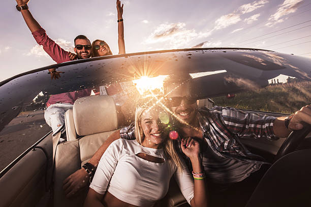 istock Young cheerful couples having fun in cabriolet at sunset. 495175930