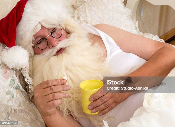 Santa Claus Taking Medicine Stock Photo - Download Image Now - Bed - Furniture, Cold And Flu, Cold Virus