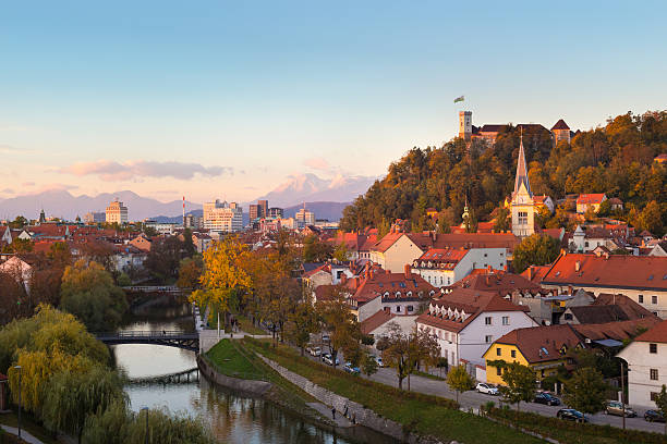 Panorama of Ljubljana, Slovenia, Europe. Cityscape of the Slovenian capital Ljubljana at sunset. Ljubljana castle on hill above town. River Ljubljanica running trough city center. Karavanke mountains in background. ljubljana castle stock pictures, royalty-free photos & images