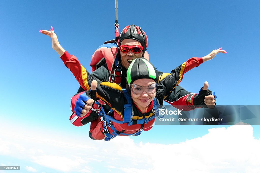 Skydiving photo. Tandem. Tandem jump. The girl with the instructor in freefall. Skydiving Stock Photo